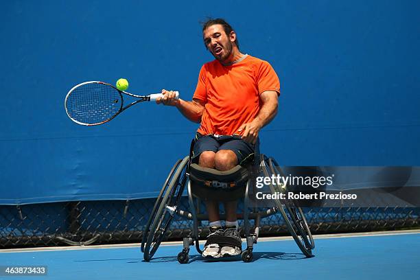 Adam Kellerman of Australia plays a forehand in his Wheelchair Wildcard Playoff Final against Ben Weekes of Australia ahead of the 2014 Australian...