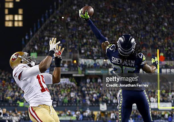 Cornerback Richard Sherman of the Seattle Seahawks tips the ball up in the air as outside linebacker Malcolm Smith catches it to clinch the victory...