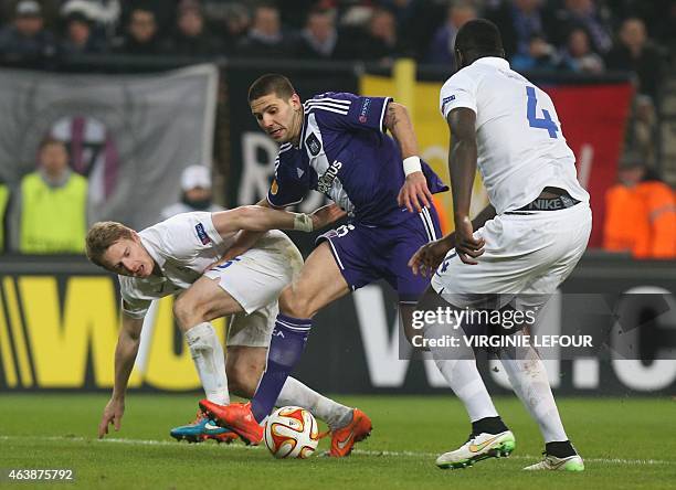 Dynamo's Tomas Hubocan , Anderlecht's Alexandar Mitrovic and Dynamo's Christopher Samba fight for the ball during their UEFA Europa League round of...