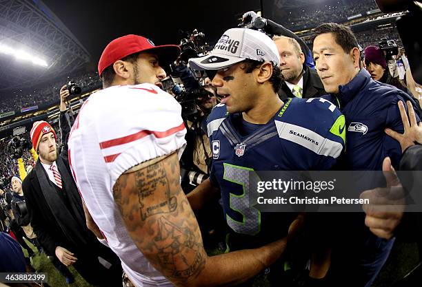 Quarterback Colin Kaepernick of the San Francisco 49ers shakes hands with quarterback Russell Wilson of the Seattle Seahawks after the Seahawks...