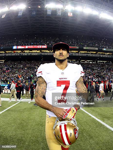 Quarterback Colin Kaepernick of the San Francisco 49ers walks off the field after losing to the Seattle Seahawks 23-17 during the 2014 NFC...