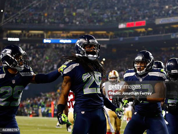 Cornerback Richard Sherman of the Seattle Seahawks celebrates after he tips the ball leading to an intereption by outside linebacker Malcolm Smith to...