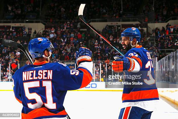 Brian Strait of the New York Islanders is congratulated by Frans Nielsen of the New York Islanders after scoring a first period goal against the...