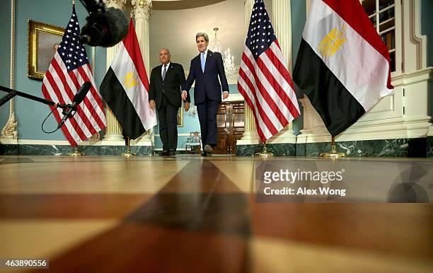 Secretary of State John Kerry and Egyptian Foreign Minister Sameh Shoukry come out to speak to members of the media prior to a meeting February 19,...