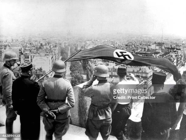 German occupation of Paris, World War II, June 1940. The Nazi flag flying from the Arc de Triomphe.
