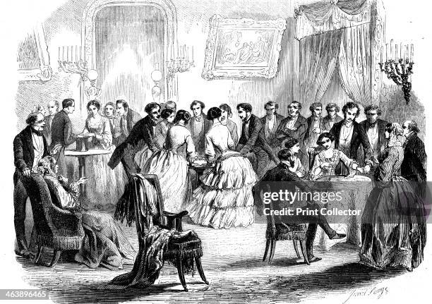 Spiritualist meeting in a Paris drawing room, 1853. Communicating with the 'other side' by means of the hat, table-turning, and the pendulum. From...