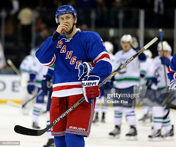 Derek Stepan of the New York Rangers reacts to the loss against the Vancouver Canucks on February 19, 2015 at Madison Square Garden in New York...