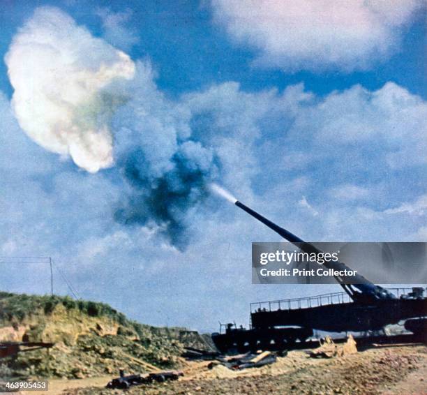 Second after the command to fire, French Channel coast, World War II, 1940. A German Krupp K5 railway gun firing shells across the English Channel at...