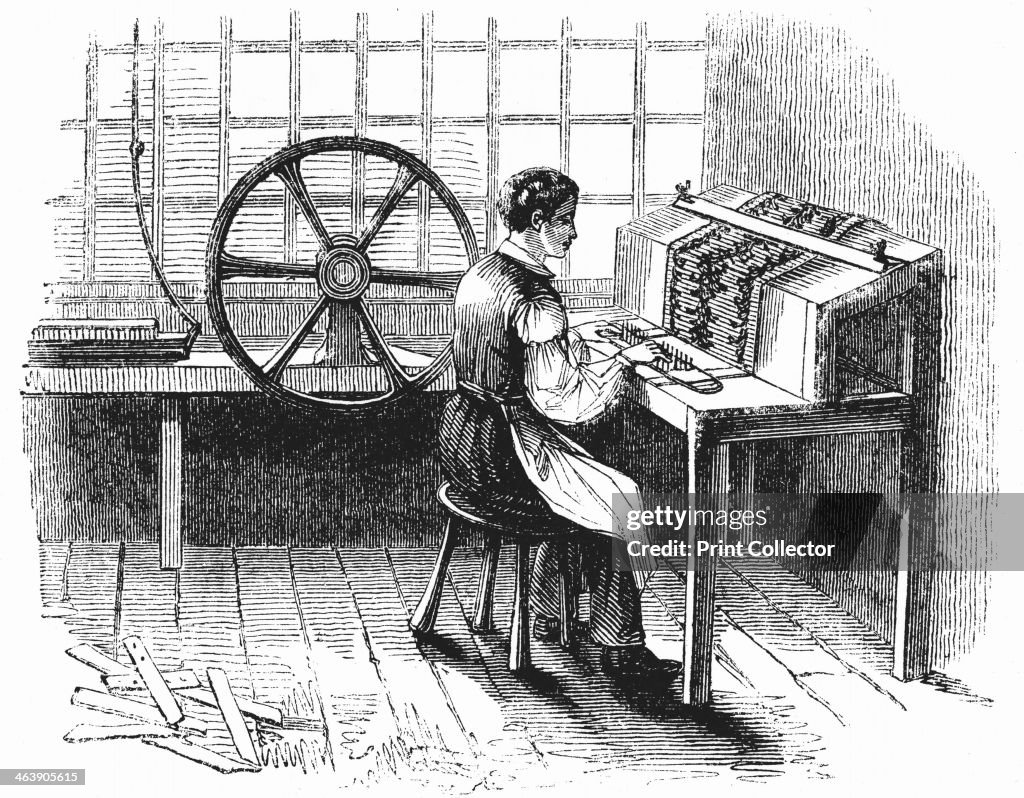 Man operating machine punching cards for Jacquard looms, 1844.