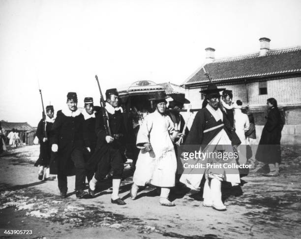 Japanese official with an escort of soldiers, Korea, c1900.