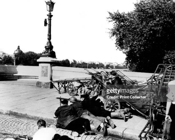 The liberation of Paris, August 1944. French francs-tireurs at a barricade on the Pont Neuf. As Allied forces neared Paris, the city's citizens...
