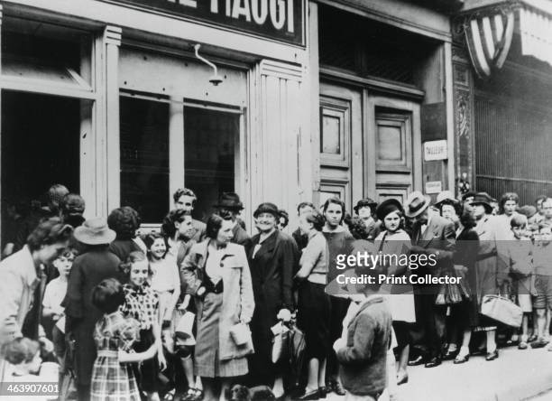 People queuing outside a dairy shop, German-occupied Paris, 26 July 1940. Shortages and rationing were a feature of everyday life for Parisians...