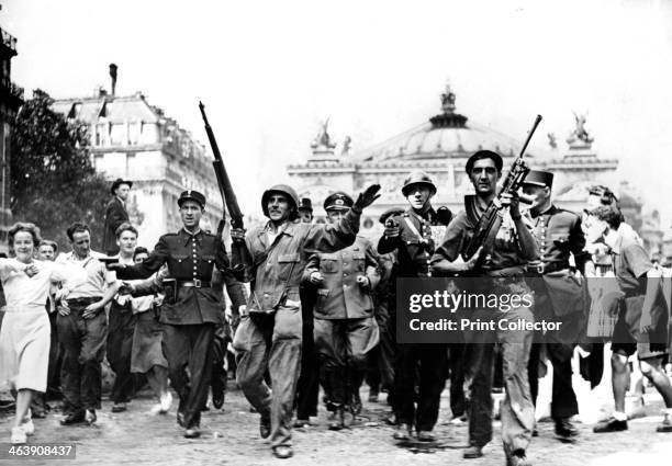 Liberation of Paris, 25 August 1944. Gendarmes, soldiers and Resistance fighters escorting German prisoners through crowds of jubilant civilians in...