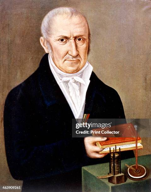 Alessandro Volta Italian physicist. On the table are two of his inventions, the Voltaic pile on the left, and the electrophorus, an apparatus...