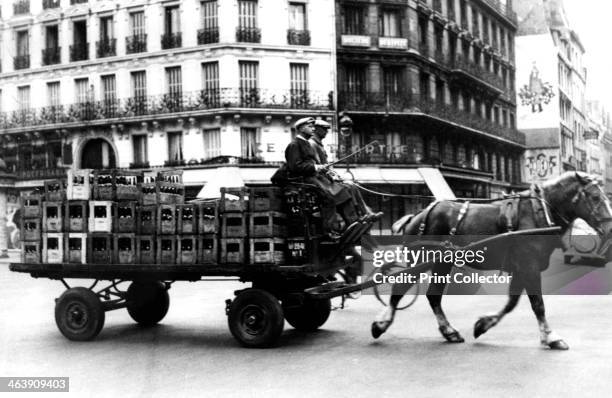 Horse-drawn cart carrying crates of drink, German-occupied Paris, July 1940. Under the German occupation, petrol was unobtainable. Only police cars...