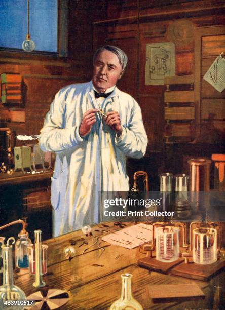 Thomas Alva Edison, American inventor, in his laboratory at Menlo Park, New Jersey, USA, working on the perfection of the incandescent light bulb,...