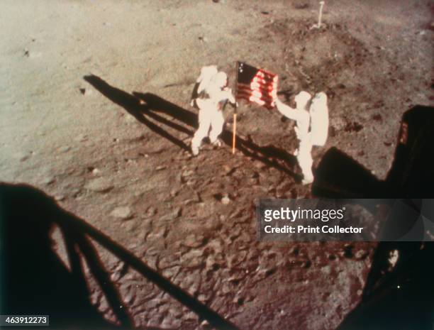 Armstrong and Aldrin unfurl the US flag on the moon, 1969. Apollo 11, the first manned lunar landing mission, was launched on 16 July 1969 and Neil...