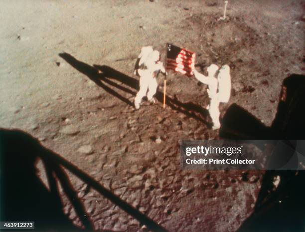 Armstrong and Aldrin unfurl the US flag on the moon, 1969. Apollo 11, the first manned lunar landing mission, was launched on 16 July 1969 and Neil...