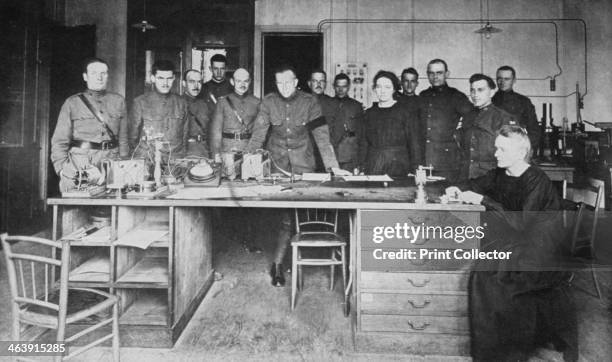 Marie Curie, Polish-born French physicist, together with her daughter Irene, and pupils from the American Expeditionary Corps at the Institute of...