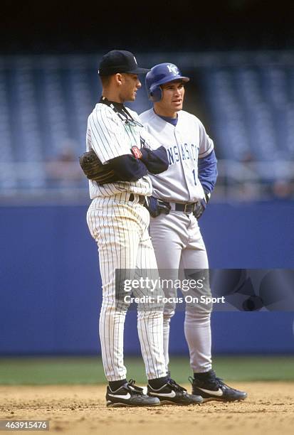 Derek Jeter of the New York Yankees and Johnny Damon of the Kansas City Royals looks on during a pitching change in a Major League Baseball game...