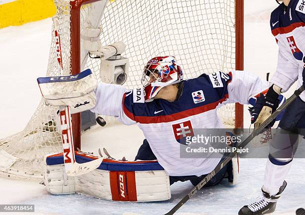 Goaltender Denis Godla of Slovakia watches the puck pass over the goal line on a shot from Nic Petan of Canada during the 2015 IIHF World Junior...
