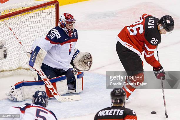 Forward Curtis Lazar of Canada moves the puck against goaltender Denis Godla of Slovakia during the 2015 IIHF World Junior Championship on January...