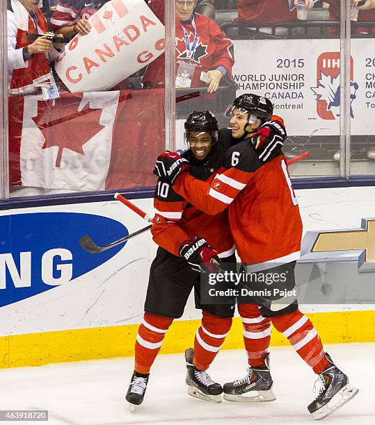 Forward Anthony Duclair and defenceman Shea Theodore of Canada celebrate a goal against Slovakia during the 2015 IIHF World Junior Championship on...