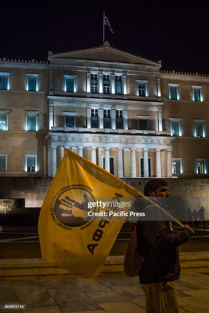 Demonstrator holds a flag of  KEERFA (Movement Against...