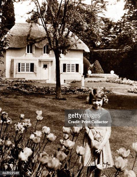 Princess Elizabeth, future Queen of Great Britain, Windsor, 1930s. Elizabeth as a child in the garden of the Royal Lodge, Windsor with Y Bwthyn Bach...