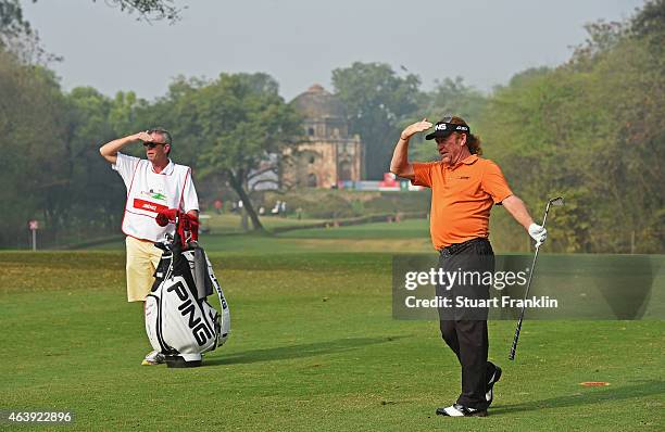 Miguel Angel Jimenez of Spain and caddie Paul Smith watch a shot during the second round of the Hero India Open Golf at Delhi Golf Club on February...