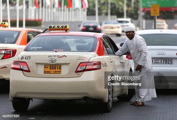 Dubai taxis wait for customers outside Dubai Mall in Dubai, United Arab Emirates, on Friday, Nov. 7, 2014. The United Arab Emirates' central bank...