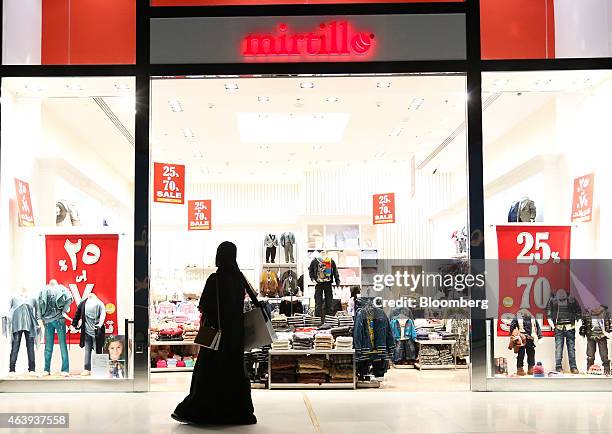 Female shopper wearing an hijab passes the entrance to a Mirtillo children's fashion store in the Dubai Mall, operated by Emaar Malls Group, in...