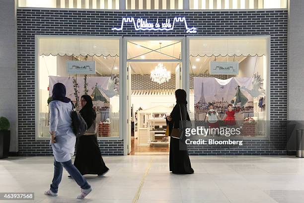 Visitor wearing an hijab browses the window display of a Chateau de Sable children's fashion store in the Dubai Mall, operated by Emaar Malls Group,...