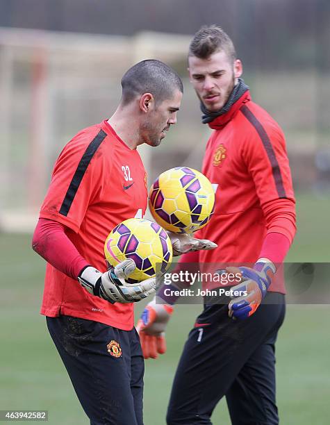 Victor Valdes and David de Gea of Manchester United in action during a first team training session at Aon Training Complex on February 20, 2015 in...