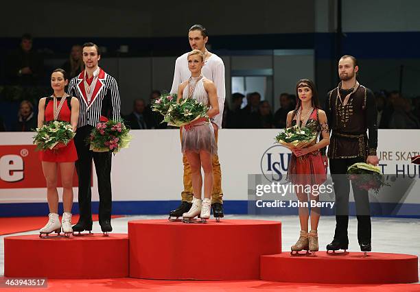 Tatiana Volosozhar and Maxim Trankov of Russia win the gold medal in front of silver medal Ksenia Stolbova and Fedor Klimov of Russia and Vera...