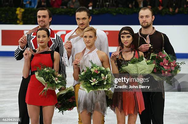 Tatiana Volosozhar and Maxim Trankov of Russia win the gold medal in front of silver medal Ksenia Stolbova and Fedor Klimov of Russia and Vera...