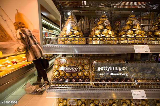 Customer shops near a display of Ferrero Rocher chocolates inside an Azbuka Vkusa OOO, which translates as "Elements of Taste," supermarket at the...