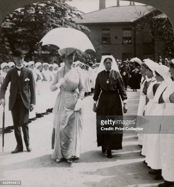 Queen Mary visiting the Royal Naval Hospital, Hull, Humberside, World War I, 1914-1918. The Queen walking through a guard of honour of nurses....