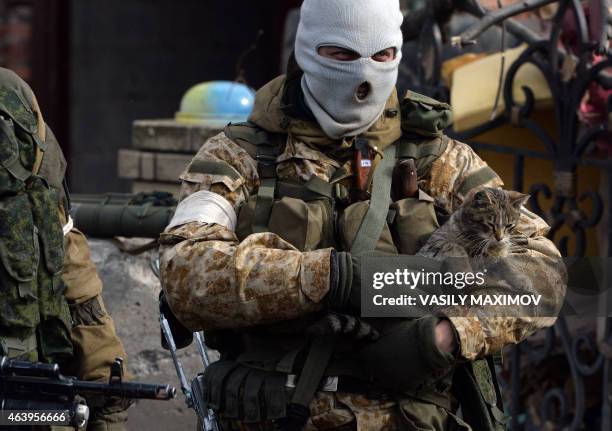 An armed pro-Russian rebel holds a cat in the eastern Ukrainian city of Debaltseve in the Donetsk region, on February 20, 2015. The EU head Donald...