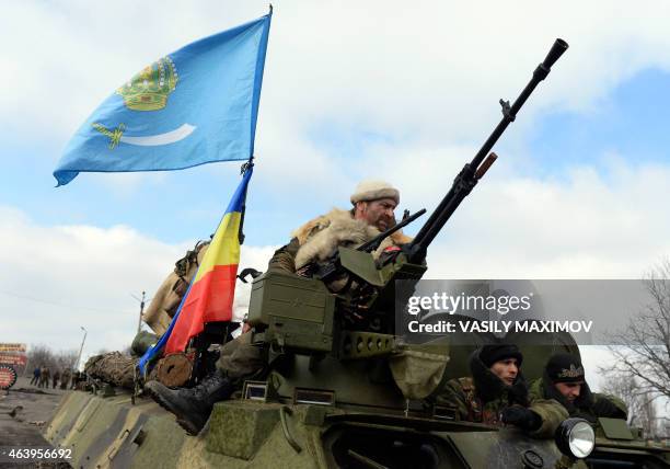 Armed pro-Russian rebel ride an Armoured Personnel Carrier in the eastern Ukrainian city of Debaltseve in the Donetsk region, on February 20, 2015....
