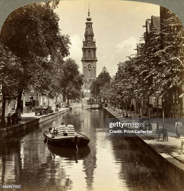 Canal, Amsterdam, Netherlands. The tower of the Zuiderkerk is in the background. The church was designed by Hendrick de Keyser and was built between...
