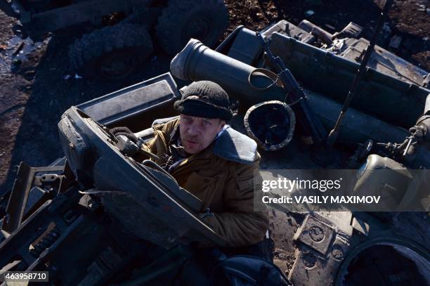 Pro-Russian rebel stand looks from the captured Ukrainian tank near the eastern Ukrainian city of Debaltseve in Donetsk region, on February 20, 2015....