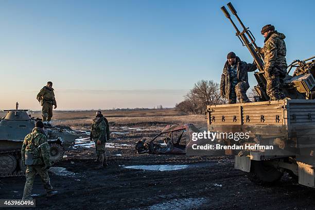 Group of pro-Russian Cossack rebel fighters organize equipment, some of which was captured from the Ukrainian Army, on February 20, 2015 in...