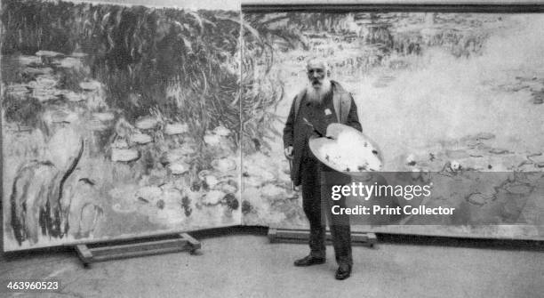 Claude Monet, French Impressionist painter, 1923. Monet in front of one of the vast canvases of the waterlilies in his garden at Giverny that he...