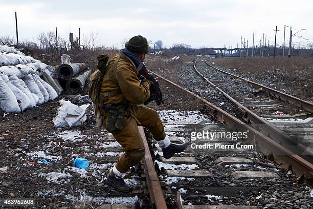 Pro-Russian fighters take position outside the train station of Debaltseve as a shell exploded near by on February 20 , 2015 . The strategic railway...
