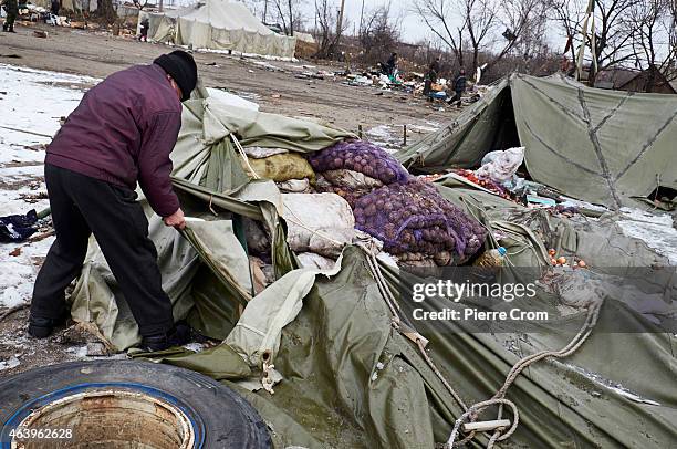 Inhabitants collect food and belongings left behind by Ukrainian forces on February 20, 2015 in Debaltseve, Ukraine. The strategic railway town of...