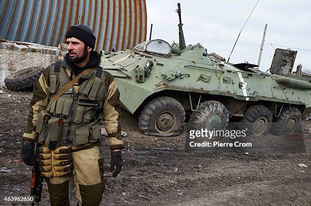 Pro-Russian fighter from Chechnya stands near a damaged Ukrainian armoured vehicle on February 20, 2015 in Debaltseve, Ukraine. The strategic railway...