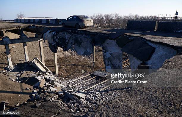 Car drives on a partly blown up bridge on February 20, 2015 in Debaltseve, Ukraine. The strategic railway town of Debaltseve is of under the control...