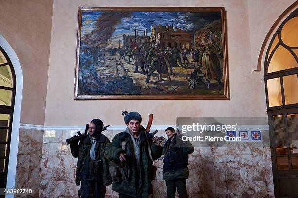 Pro-Russian fighters stand inside the train station under a painting showing a scene of the second World war on February 20, 2015 in Debaltseve,...