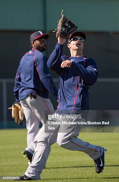 Daniel Nava of the Boston Red Sox tracks a fly ball while Jackie Bradley Jr. Watches during a Spring Training workout at Fenway South in Fort Myers,...